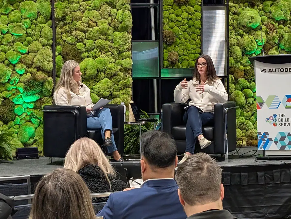 Agnes and Leslie in a fireside chat on stage at The Buildings Show, audience in the foreground